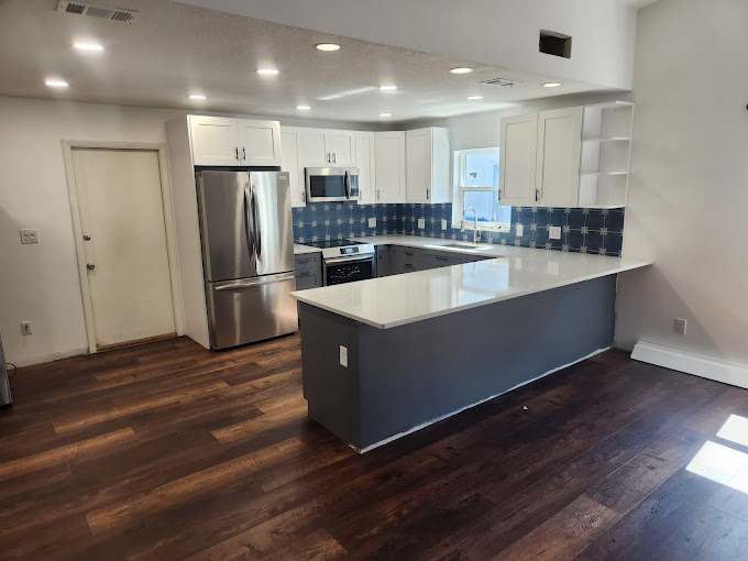 A kitchen with a large island in the middle of it