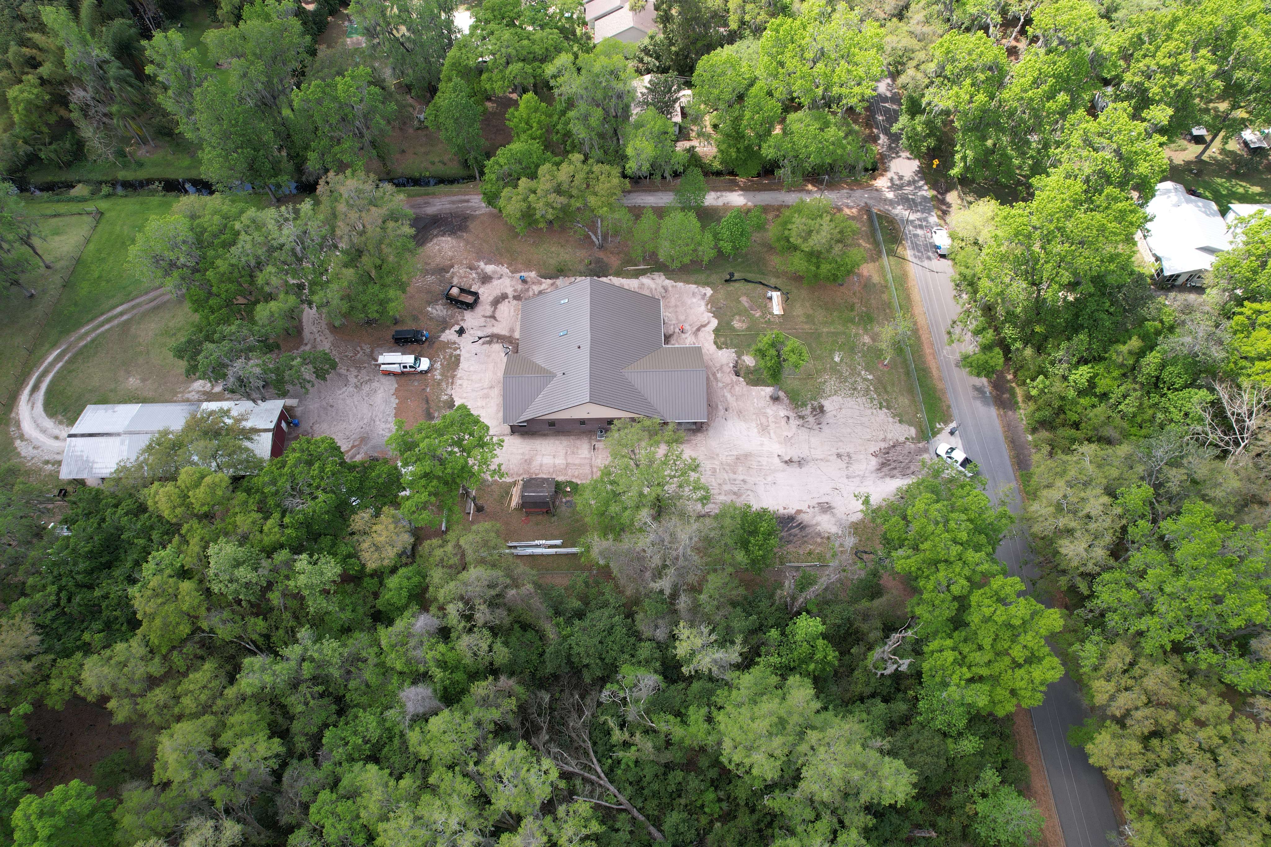 An aerial view of a house surrounded by trees