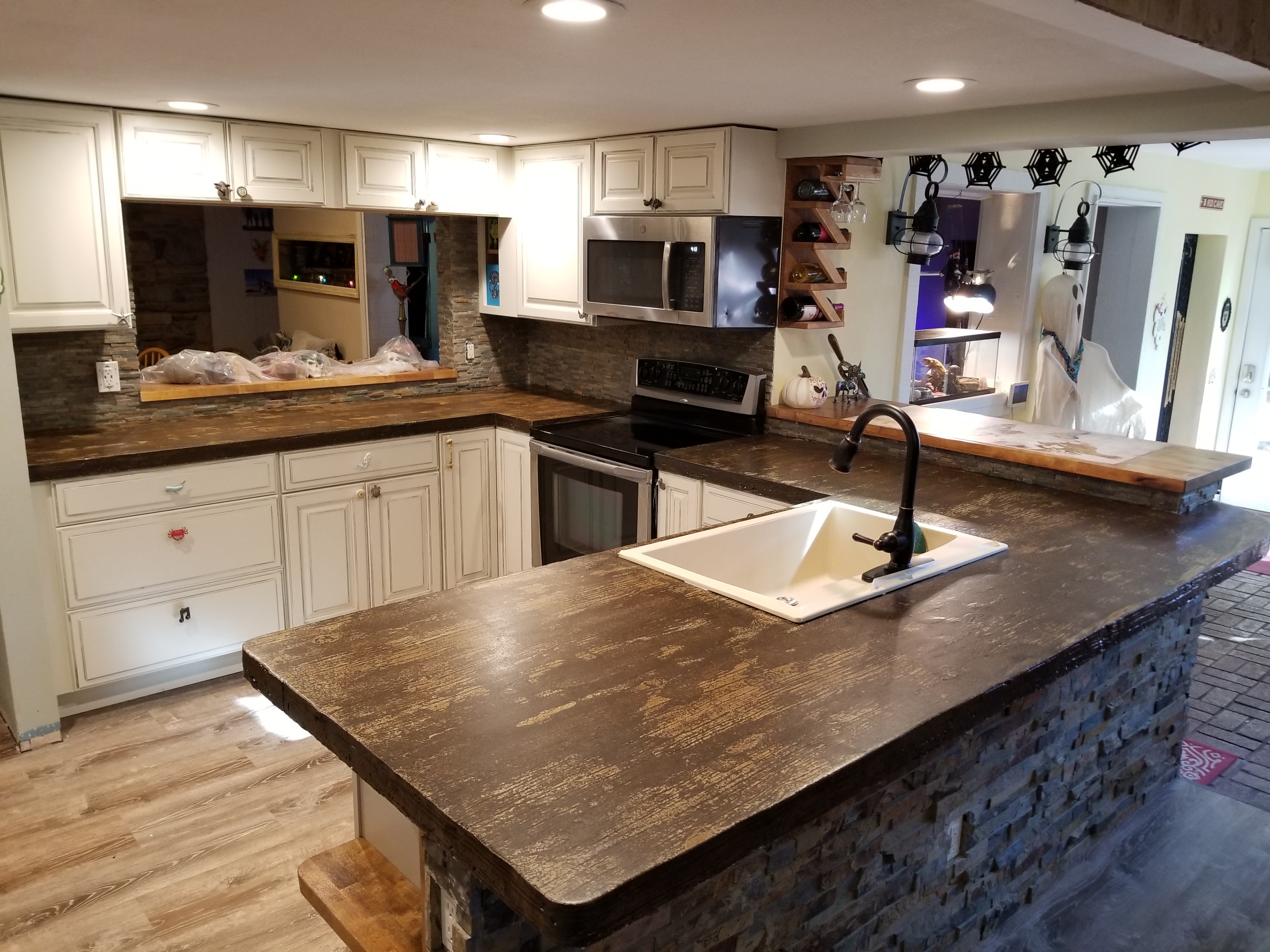 A kitchen with a sink and a stove top oven