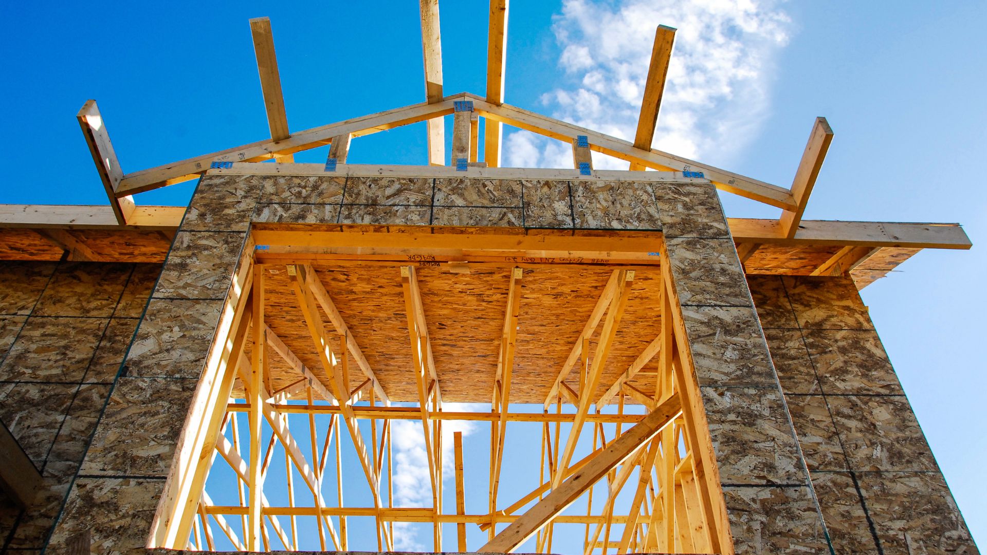 A building under construction with a blue sky in the background